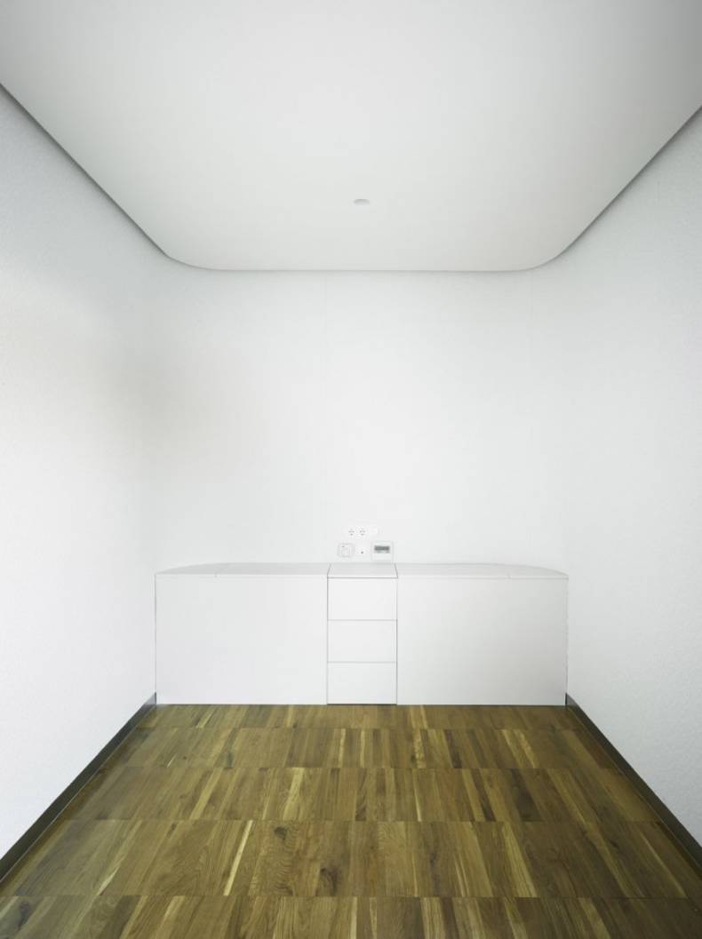 Refurbished Attic With Glossy White Facade by Clavel Arquitectos